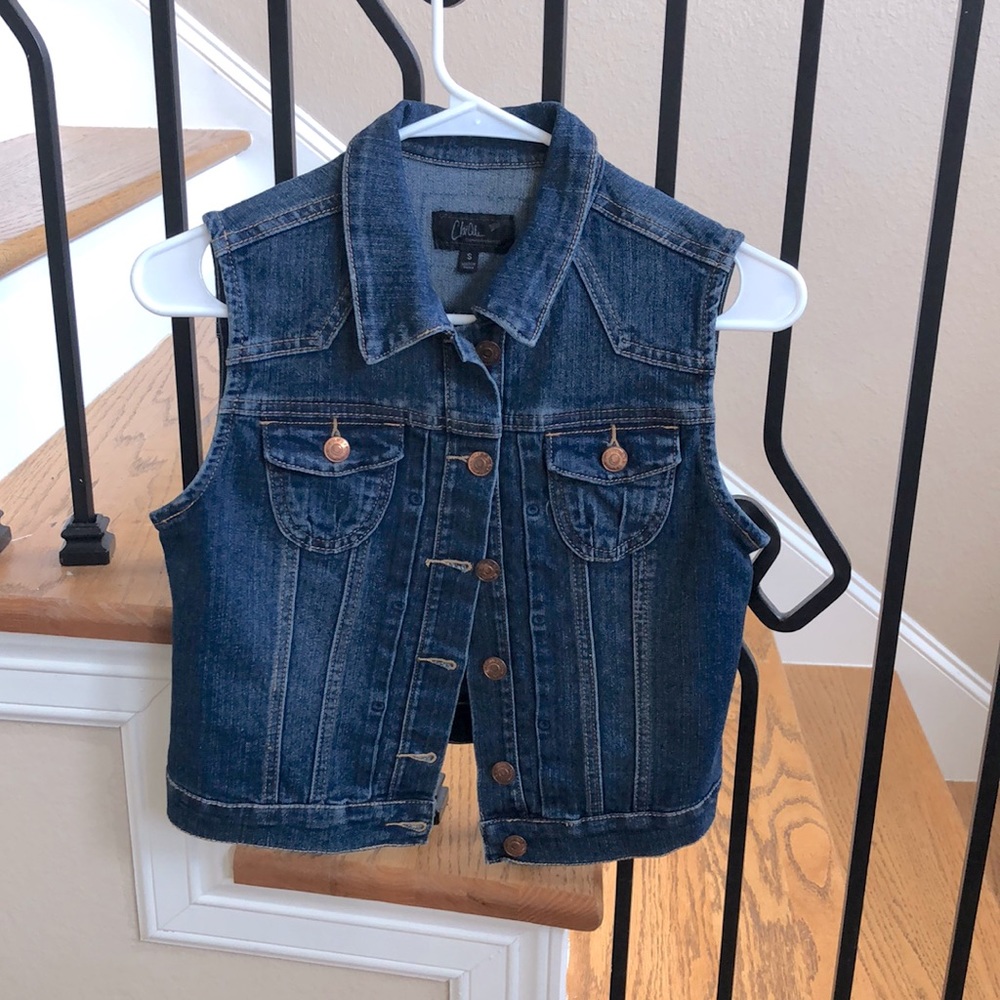 Crop denim jacket with no sleeves. True to size.